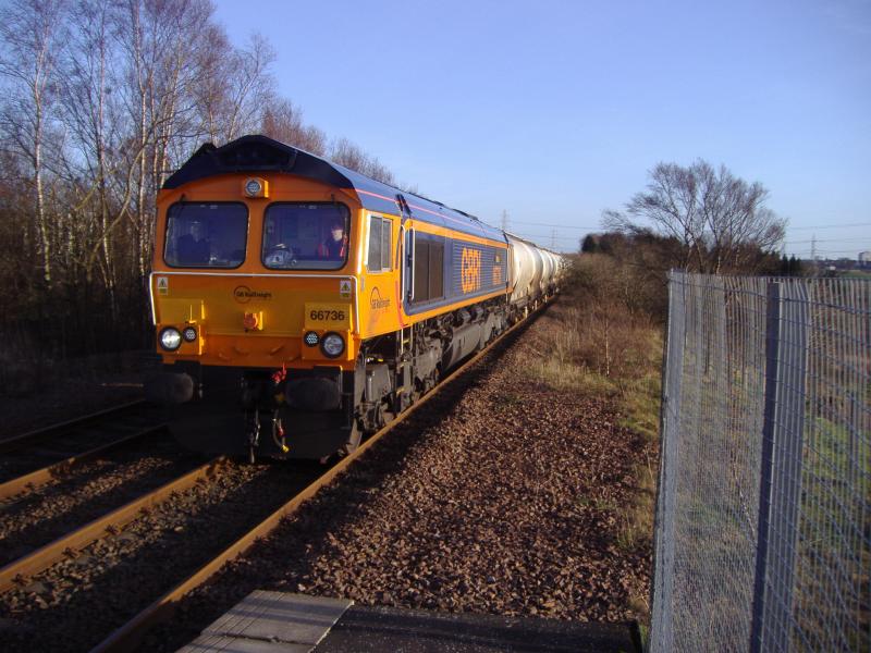 66 736 at Gartcosh: 66 736 about to pass Gartcosh Station on the 6S45 North Blyth to Fort William service. (12.01.12) Photo of 66 736 at Gartcosh