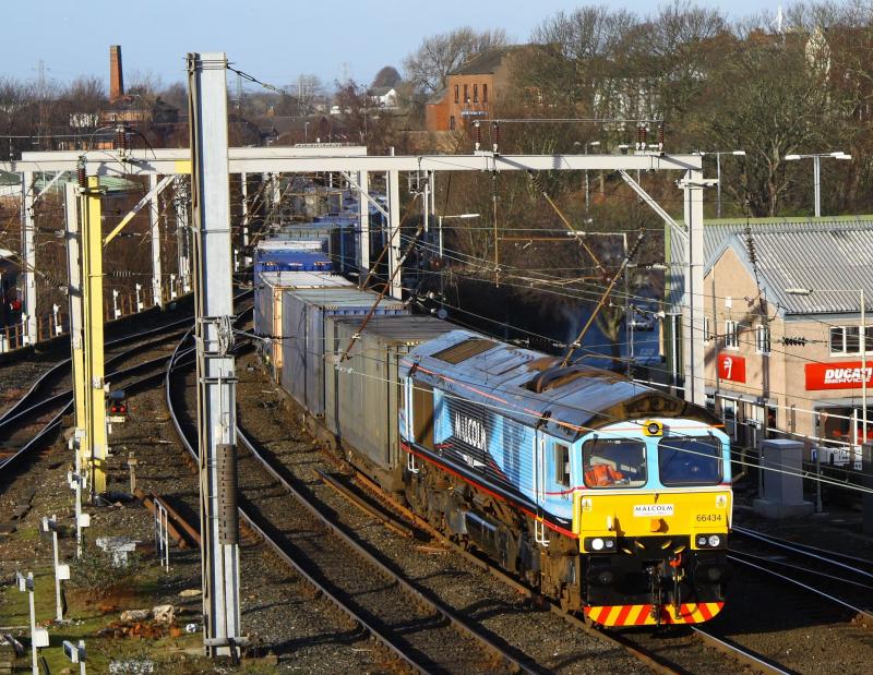66434: 66434 Working 4m44 Grangemouth - Daventry seen here approaching Carlisle station with its first working since being re-vinyled in Malcolm livery 66434 was attached at Kingmoor with 66429 being removed having worked from Grangemouth. 19/01/2012 Photo of 66434