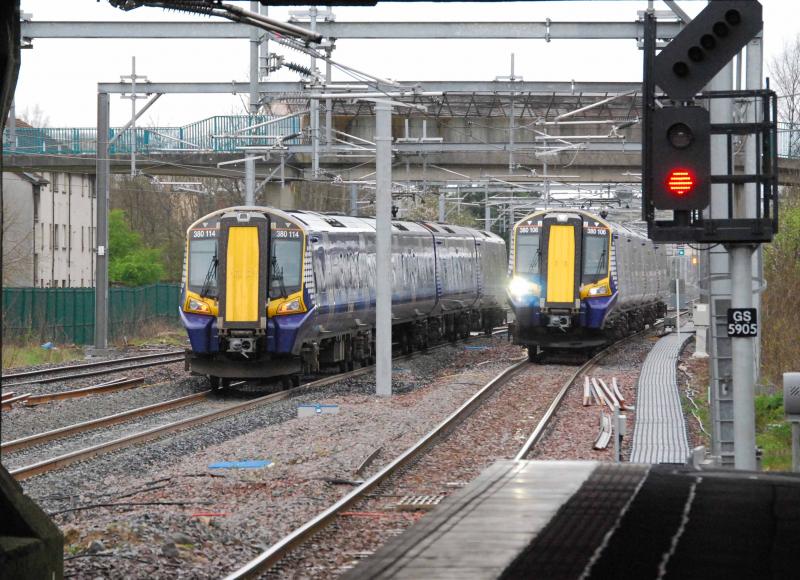 380114 on Centre Road: Cardonald on a wet day, as usual
380114 on a Glasgow bound service passes 380106 going towards PGS on a Route Learning Trip on the New Centre Track Photo of 380114 on Centre Road