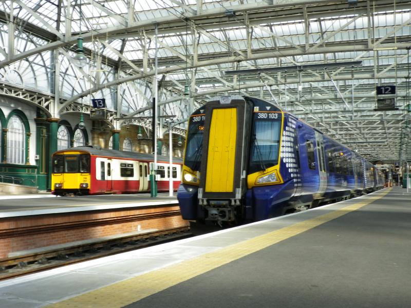 Contrasting Styles: Class 156 and 380 (on the new platform) at Glasgow Central in late May 2011. A welcome to Glasgow from Tanzania. Photo of Contrasting Styles