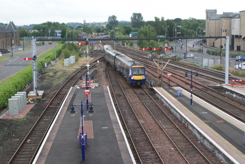 The skeleton of Stirling's new signal gantry no.2: The skeleton of Stirling's new signal gantry erected during the early hours today with 170393 arriving into Platform 6 Photo of The skeleton of Stirling's new signal gantry no.2