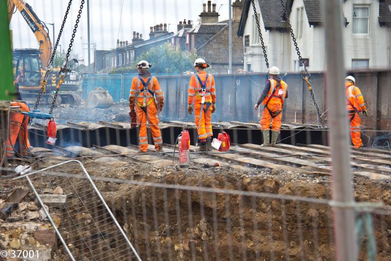 And without a sound it is removed: Some folk didn't even notice the crane gently lift this section away from the bridge as the hi vis men look on at Larbert rail bridge Photo of And without a sound it is removed