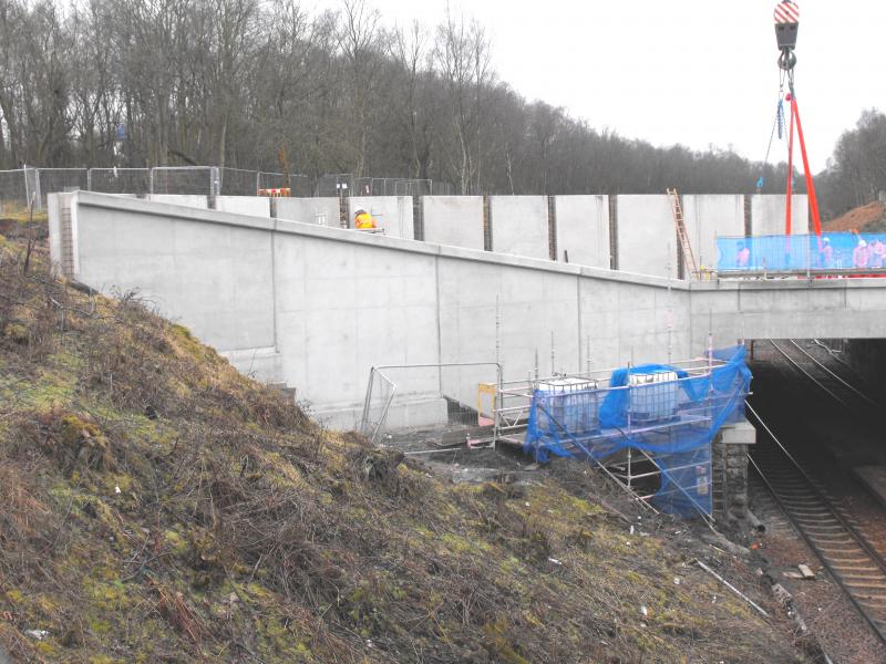 worker ties block into place: The crane will be on site from Saturday evening until Tuesday loading these blocks into place for the aqueduct. Photo of worker ties block into place