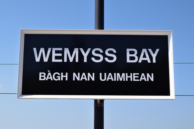 Wemyss Bay station name sign: Caledonian-style signs have replaced the standard Scotrail ones - but the Caley never gave names in Gaelic! Photo of Wemyss Bay station name sign