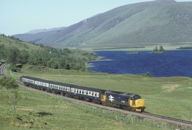 37 416 on the Kyle Line: 37 416 skirts Loch Sgamhain with the 07.10 Kyle to Inverness. 21st June 1986 Photo of 37 416 on the Kyle Line