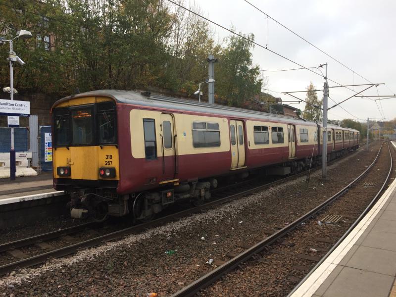 318267 at Hamilton Central: 318267 calls at Hamilton Central on Monday 31st October while forming the 2L19 10:33 Larkhall to Milngavie. There are currently only seven carmine & cream liveried Class 318 units remaining. Photo of 318267 at Hamilton Central