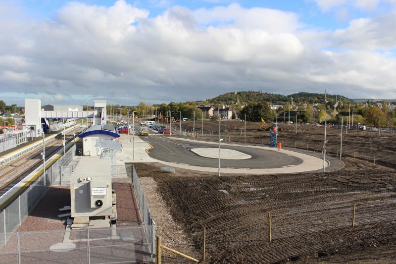 Forres new station: Station forecourt and earth-mounded area below which the old railway formation is lost, 18 October 2017 Photo of Forres new station