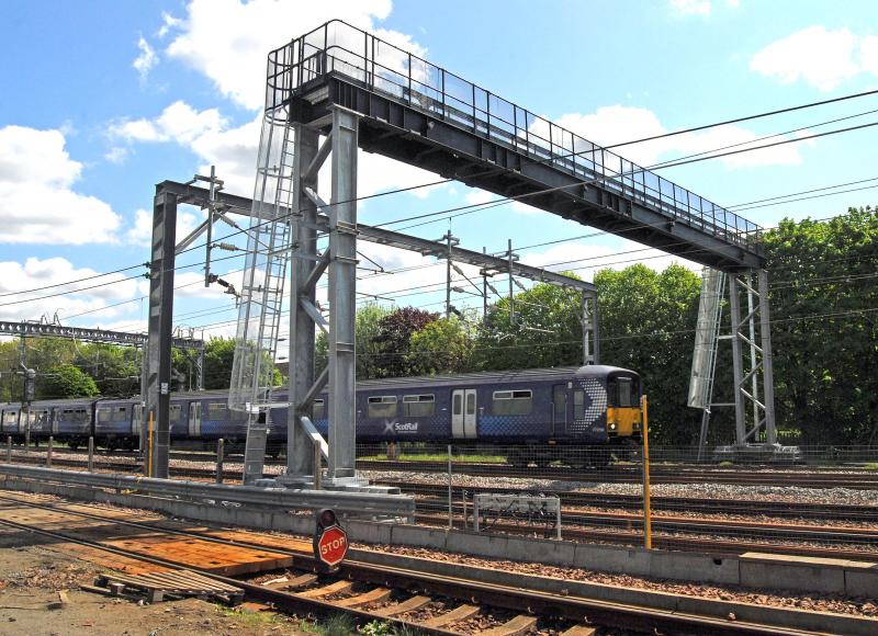 New Signal Gantry @ Rutherglen East Junction: This huge new signal gantry was installed over the Weekend of 12th May @ Rutherglen East Junction.
This picture was taken at the (OTPD) On Track Plant Depot Photo of New Signal Gantry @ Rutherglen East Junction