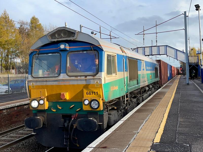Sun Sence: Aggregates Industries liveried GBRf 66711 heads a fully stacked 4S69 Tees - Elderslie through Holytown station in the last of the sunlight as sunset is just over an hour away. (08/11/2022) Photo of Sun Sence