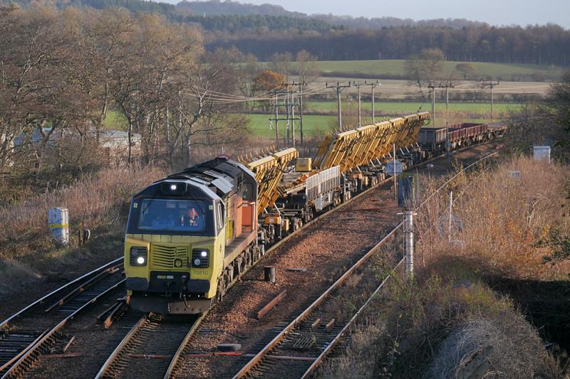 Inverkeithing 70: Colas 70810 passes Inverkeithing East Junction with 6K10 from Dundee to Millerhill with carriers for pre-fabricated turnouts in the consist. 27 November. Photo of Inverkeithing 70
