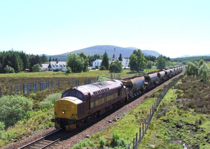 37 670 passing Dalwhinnie: Doh ! Too much sun. Ballast Wagons for Achnasheen. 23/6/2009 Photo of 37 670 passing Dalwhinnie