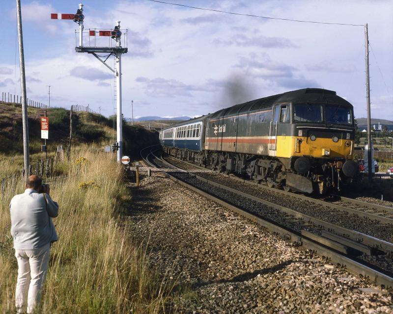 Now preserved 47643 does the honours in August 1990.: A friend provides a nice balance on the L.H.side of the picture Photo of Now preserved 47643 does the honours in August 1990.