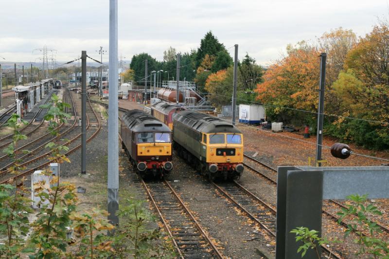 47812 blocked in by 67023: 47812 with the engine running plus driver waits for 67023 to be moved. 47804 also there.The siding to the right could have been used. Photo of 47812 blocked in by 67023