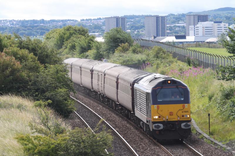 67005 leads Golfex out of Edinburgh toward Turnhouse: Backlit by the morning sun, 67005 approaches Turnhouse with Golfex 1Z59 Edinburgh to Leuchars on 18 July 2010. Photo of 67005 leads Golfex out of Edinburgh toward Turnhouse