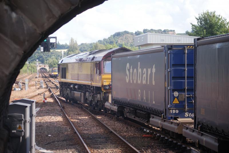 Perth Departure: This Tesco freight powered by 66113 gets the go-ahead to cross whilst a 170 Turbostar waits to enter Perth Station. Photo of Perth Departure