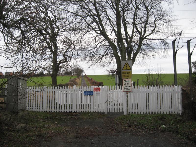 Curriehill foot crossing: Approach to north side of crossing,with Newmills Road on other side Photo of Curriehill foot crossing