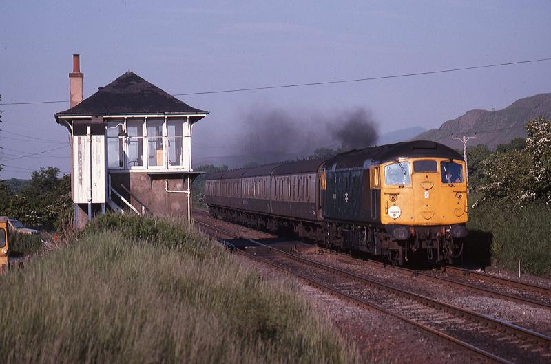 Class 26 at Camps crossing: On a July 1979 evening, 26018 passes the level crossing and Camps Junction signal box. On the north side a car waits to cross Photo of Class 26 at Camps crossing