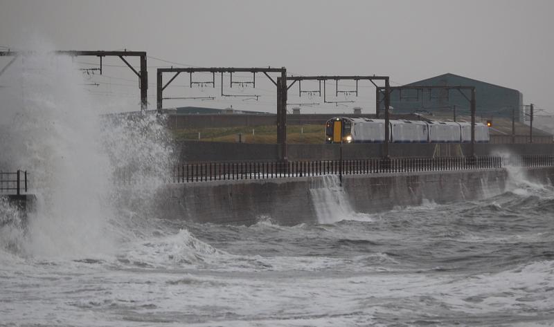 Missed me: 380115 narrowly avoids a wave at Saltcoats, while on a Glasgow-Largs working on Sep 6th 2011 Photo of Missed me