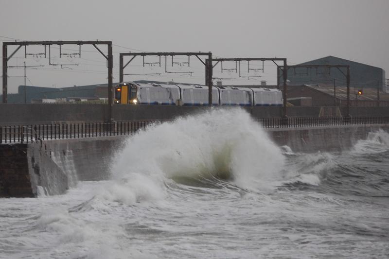 Give us a wave: 380115 about to get a soaking at Saltcoats, while working a Largs train on Sep 6th 2011 Photo of Give us a wave
